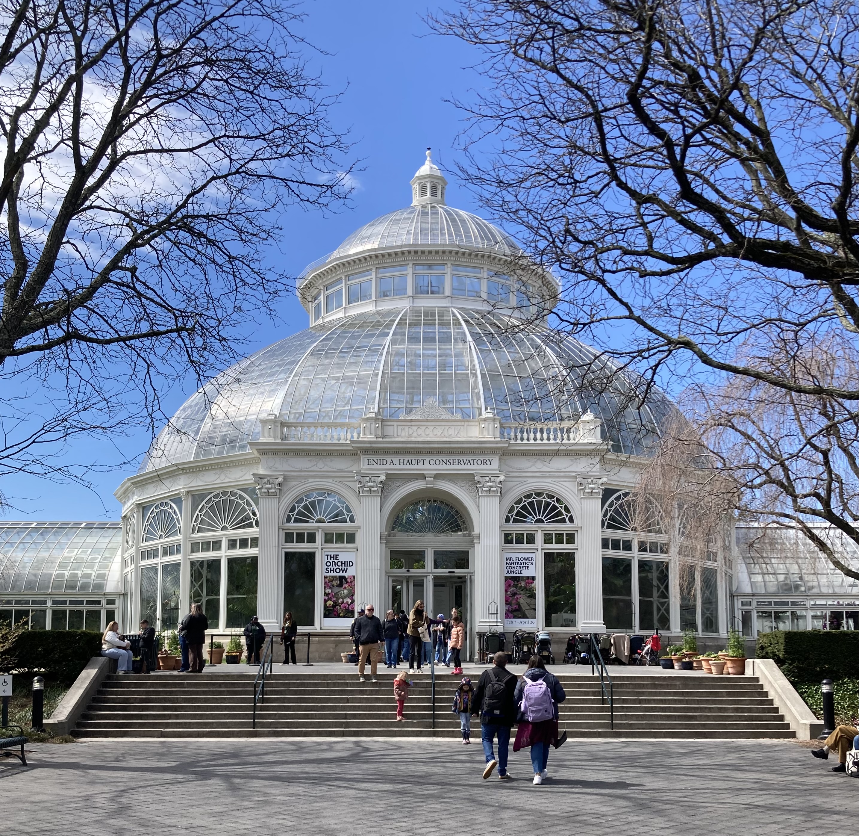 A white and glass conservatory with a blue sky above